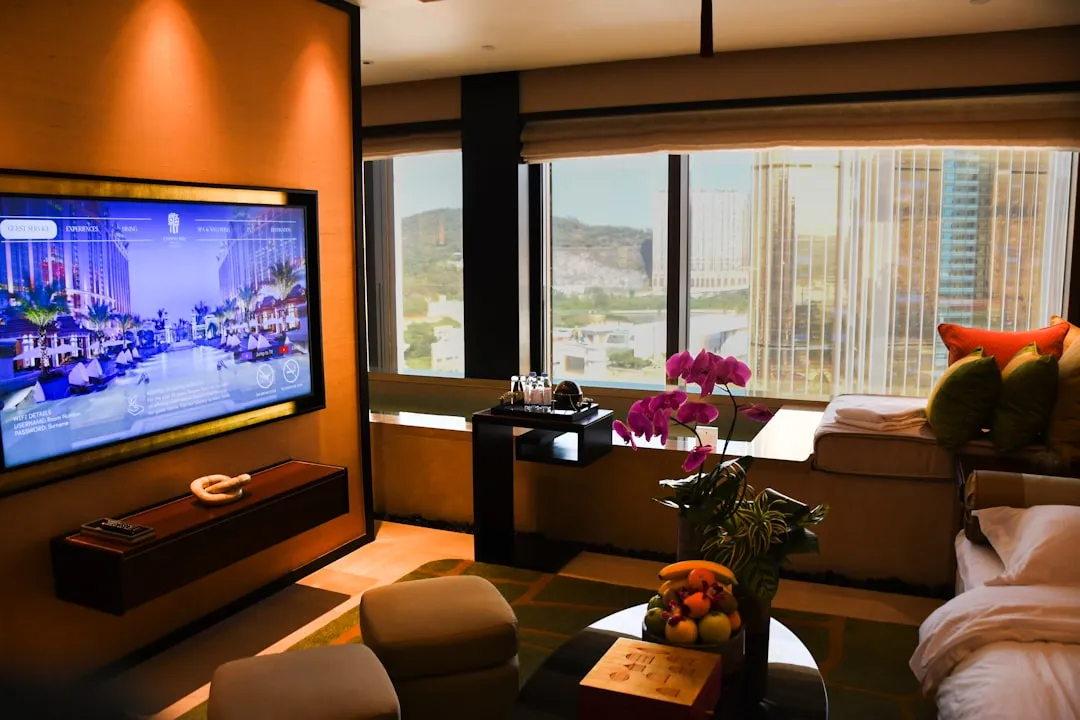 Luxurious hotel room with city view and large television
